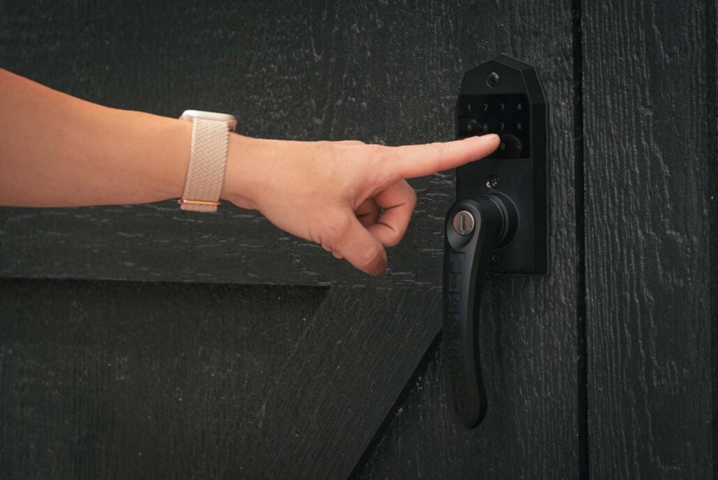 Finger using Tuff Shed keyless door handle touch screen